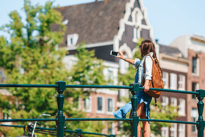 Woman photographing with mobile phone