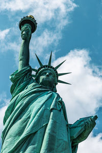 Low angle view of statue of liberty against sky