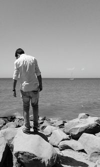 Rear view of woman standing on beach