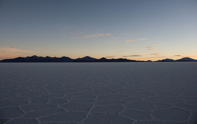 Scenic view of land against sky during sunset