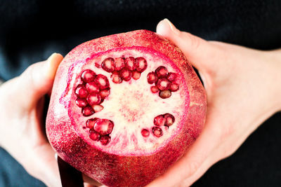 Close-up of hand holding pomegranate