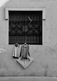 Low angle view of clothes hanging on coathangers at window
