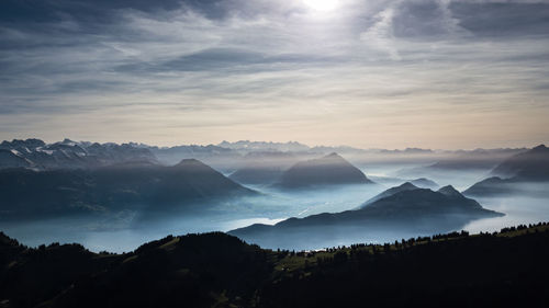 Scenic view of silhouette mountains against sky at sunset