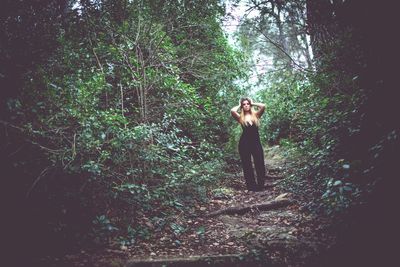 Woman standing in forest