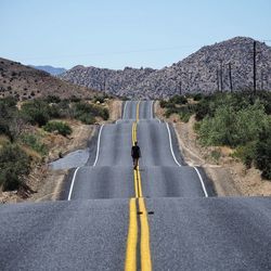 Road by mountain against clear sky