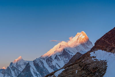 Scenic view of snowcapped mountains against clear blue sky