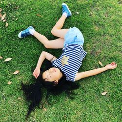 High angle view of baby lying on grassy field