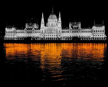 Reflection of illuminated building in water at night