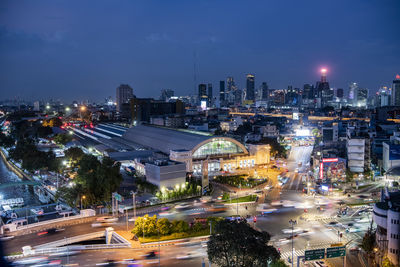 High angle view of illuminated buildings in city against sky at night