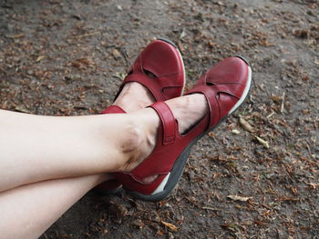 Low section of woman wearing shoes outdoors