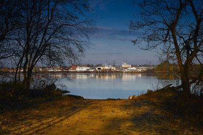 Scenic view of river by trees against sky