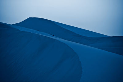 Low angle view of mountain against clear blue sky