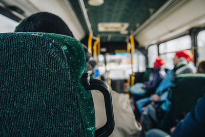 Rear view of man sitting in train