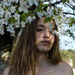 Portrait of teenage girl with white flowers