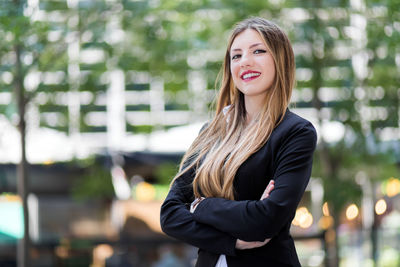 Portrait of smiling young woman standing outdoors