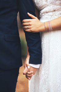 Midsection of bride holding hands