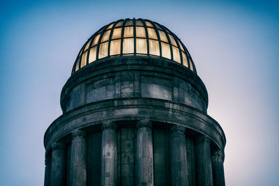 Top of a tower with glass roof illuminated from the sun