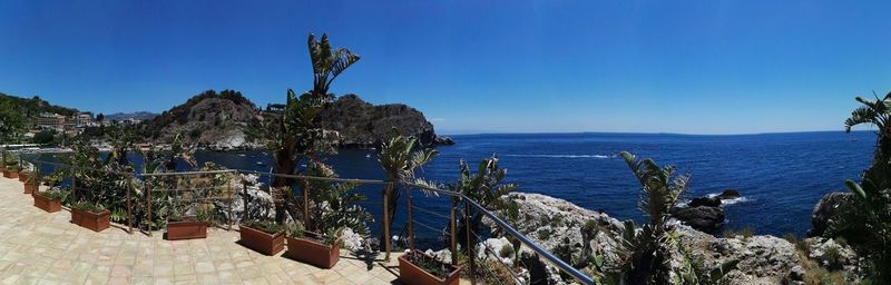 Panoramic view of sea against clear blue sky