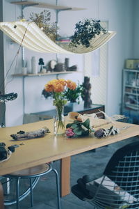 Flower vase on table in restaurant