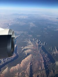 Cropped image of jet engine over landscape