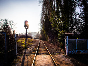 High angle view of railroad track by trees on field