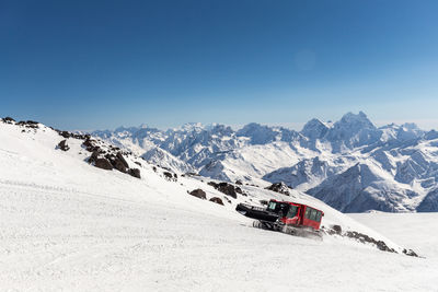 Scenic view of snowcapped mountains against clear blue sky