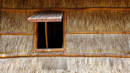 Vintage thatched wall with bamboo wooden window