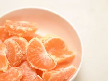 Close-up of fruits in bowl over white background