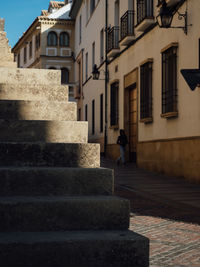 Low angle view of woman walking on building