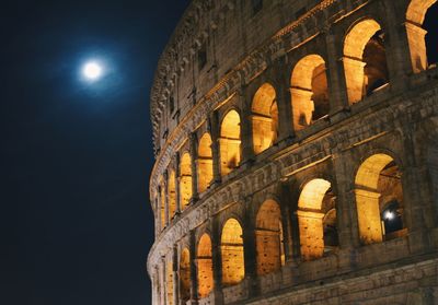 Low angle view of coliseum at night