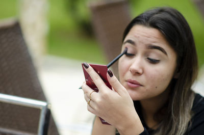 Portrait of woman holding mobile phone