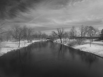 Scenic view of river against sky during winter