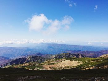 Scenic view of mountains against cloudy sky