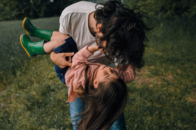 Father playing with daughter outdoors