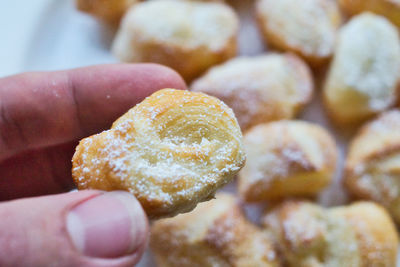 Close-up of hand holding cake