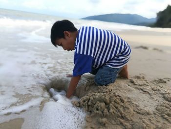 Rear view of boy on beach