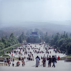 People on mountain against sky