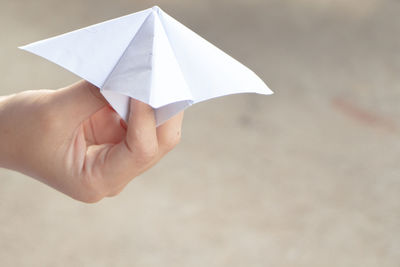 Close-up of hand playing with origami