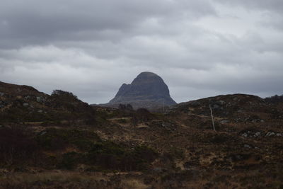 Scenic view of mountains against cloudy sky