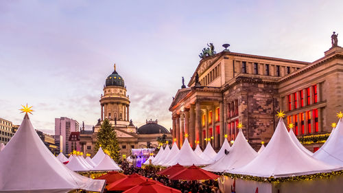 Tents outside neue kirche against sky in city during christmas