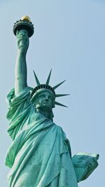 Low angle view of statue of liberty against sky