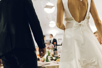 Midsection of bride and groom standing during wedding