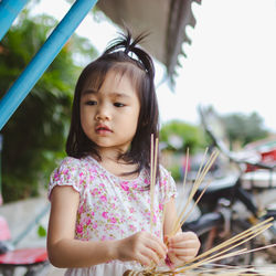 Cute girl holding sticks