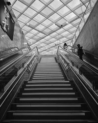 Low angle view of people on escalator