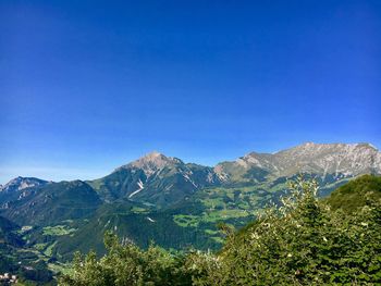 Scenic view of mountains against clear blue sky