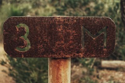 Close-up of rusty road sign