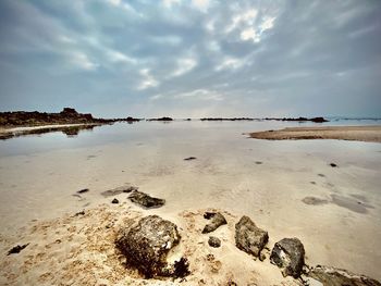 Scenic view of beach against sky