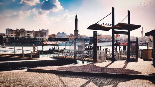 Commercial dock by sea against sky in city