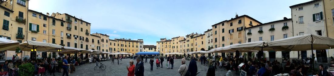 Panoramic view of crowd on street against sky