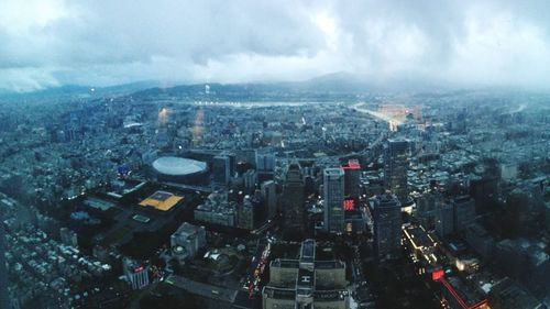 High angle view of illuminated cityscape against sky